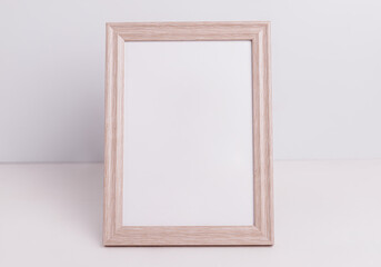 Beige photo frame stands on a white background