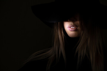 face of a girl in a hat in the dark, portrait of a girl