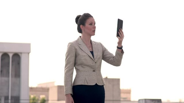 Businesswoman talks to someone on her tablet