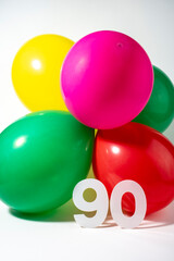 Fototapeta na wymiar Number 90 and colourful round balloons. Birthday, anniversary, jubilee concept.