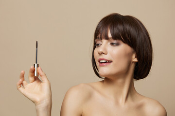 Obraz premium portrait woman smile mascara charm short haircut beige background