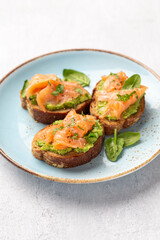 Salmon avocado keto sandwiches on healthy seed buns.