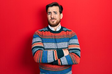 Handsome caucasian man with beard with arms crossed gesture clueless and confused expression. doubt concept.