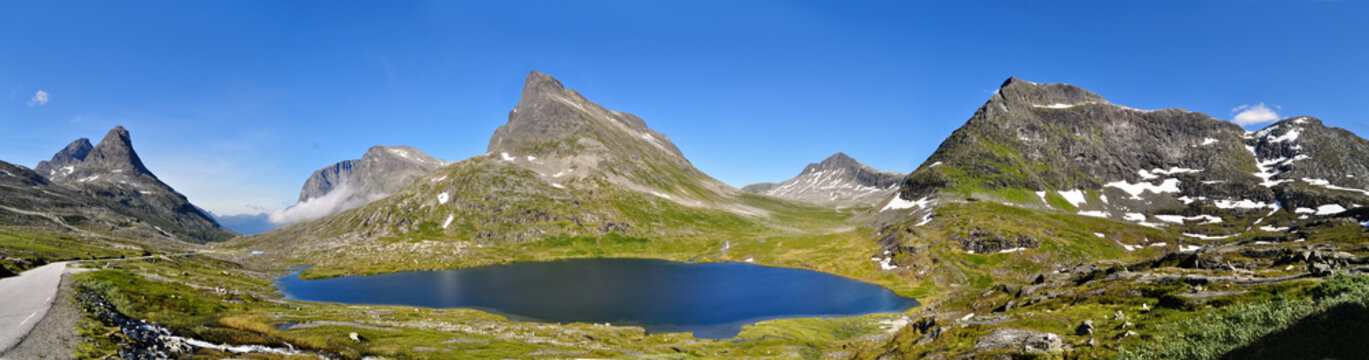 High rocky mountains, lake and road in Romsdal region, Norway