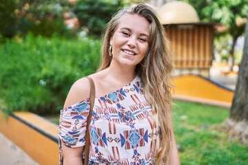 Fototapeta premium Young blonde girl smiling happy standing at the city.