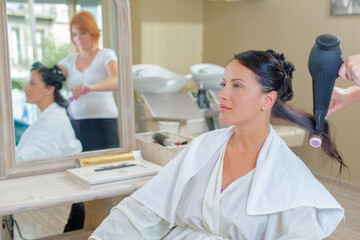 Obraz premium Lady having hair blow dried in hairdressers