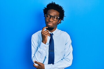 Young african american man wearing business clothes thinking concentrated about doubt with finger...