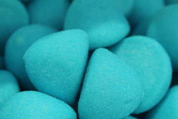 chewy blue-colored marmalade gumme shaped candy sphere truffles close-up. Background food. A day of sweet tooth