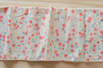 handkerchief with flowers on a wooden surface