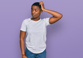 Young african american woman wearing casual white t shirt confuse and wondering about question....