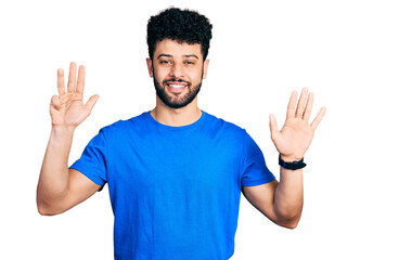 Young arab man with beard wearing casual blue t shirt showing and pointing up with fingers number nine while smiling confident and happy.