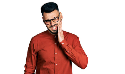 Young hispanic man with beard wearing business shirt and glasses touching mouth with hand with painful expression because of toothache or dental illness on teeth. dentist