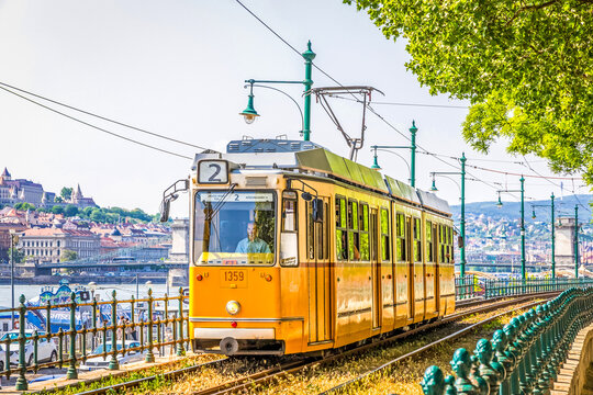 Budapest, Hungary: Tram No. 2 moves along Danube river near Petofi ter. Budapest tram network is one of world largest tram networks, total route is over 156km. In operation since 1866