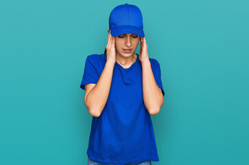 Young hispanic girl wearing delivery courier uniform with hand on head for pain in head because stress. suffering migraine.