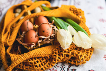 Easter eggs on rustic table with white tulips