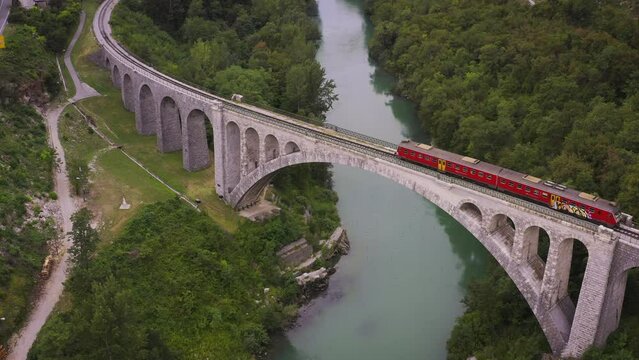 subway train passes through the viaduct river mountains forest aerial drone cinematic footage