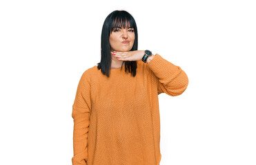 Young hispanic woman wearing casual clothes cutting throat with hand as knife, threaten aggression...