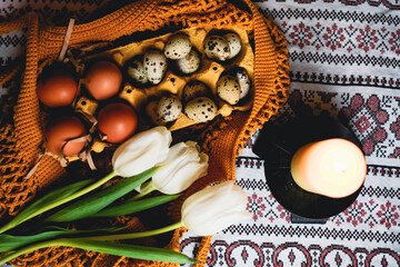 Easter eggs on rustic table with white tulips