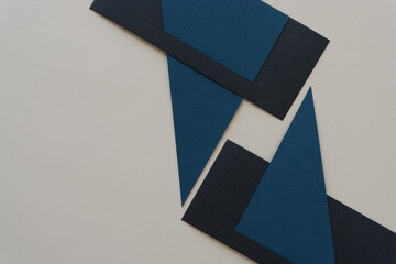 abstract geometric paper background in black and blue on gray
