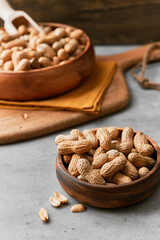 Image of bunch of peanuts in a bowl on a concrete surface