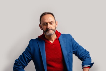 Portrait of sexy mature grey bearded man. Stylish bearded senior bearded man looking at camera isolated on grey background.