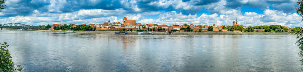 Fototapeta na wymiar Torun, Poland - August 11, 2021. Panoramic view on the Old Town of opposite side of the river