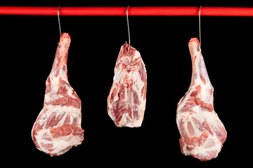 Raw lamb leg on black background. Fresh and raw meat. Uncooked leg of lamb on black background....