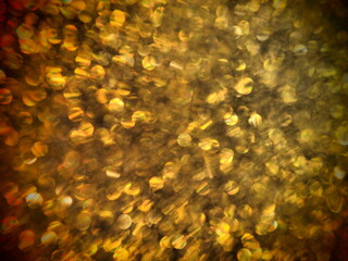Bokeh light of gold glitters. Golden glitter texture background. Sparkling glitter wrapping paper...