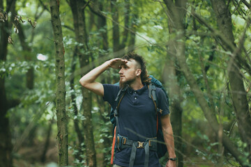 Lost young hippie hiker, searching for the path, lost in the forest, looking for the exit from the...