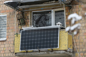 Winter view of the solar battery panel mounted on the balcony of an apartment building in Kyiv,...