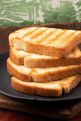 Toasted breads in a pile. .