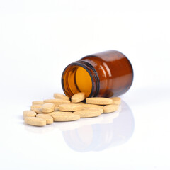 Two size of vitamin C bottle and pill with reflection