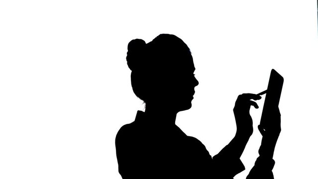 Silhouette of Businesswoman using tablet