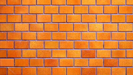 オレンジ色のグラデーションの煉瓦ブロック背景テクスチャー