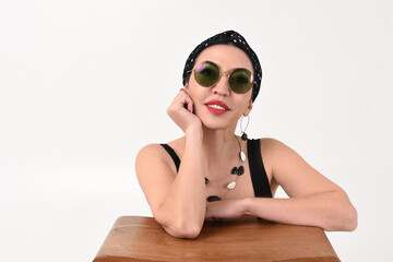 Portrait of a beautiful brunette woman with a smile on a white background in a studio with dark glasses