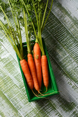 fresh organic carrots in the small green wooden box