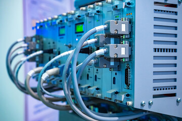 Data center equipment close up. Gray data center equipment with network cables. Telecommunication center equipment. Fragment hosting server. Hosting provider's servers. Server installation.