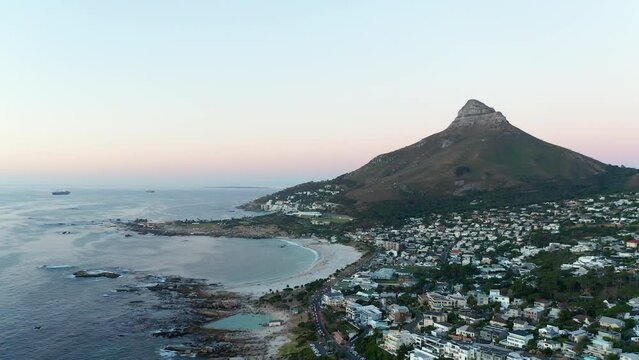 Aerial Shot Of Suburbs At Camps Bay In Cape Town With Lions Head Mountain Backdrop In South Africa.