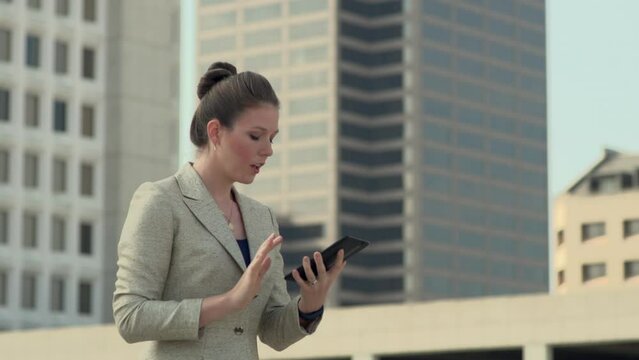 Flustered businesswoman working on tablet