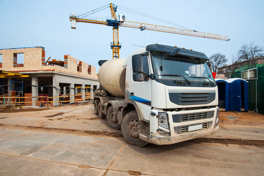 concrete mixer truck stands on construction site in winter