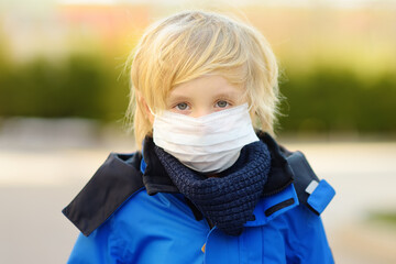Little boy wearing a protective face mask in airport, supermarket or other public place. Safety...