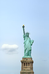 Fototapeta na wymiar The statue of Liberty on the background of blue sky, New York City, USA