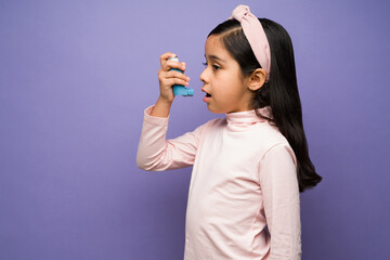Sick little girl having an asthma attack - obrazy, fototapety, plakaty