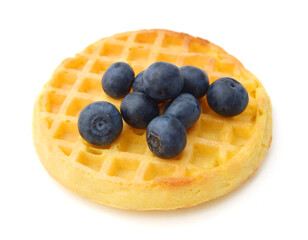 a round waffle and blue berry on a white background