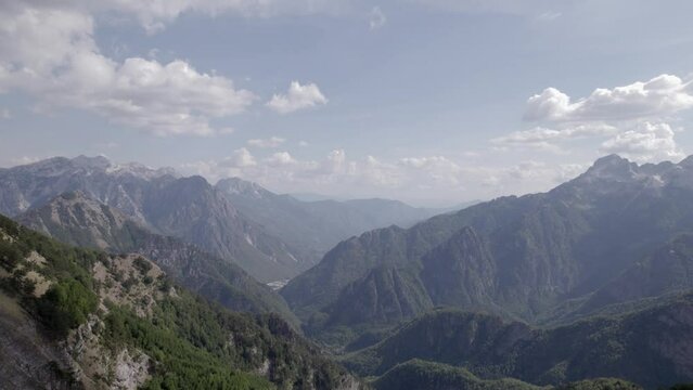 Video with drone of frontal plane advancing flying over the valley of theth, showing the entire mountainous area of northern albania, with mount Korab in the background.