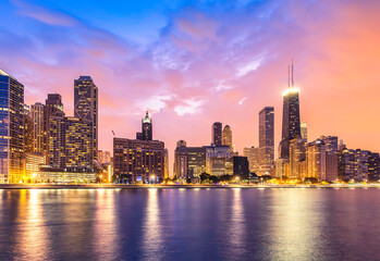 Fototapeta na wymiar Chicago Downtown at dusk with warm color sky. City lights reflected in the Lake Michigan
