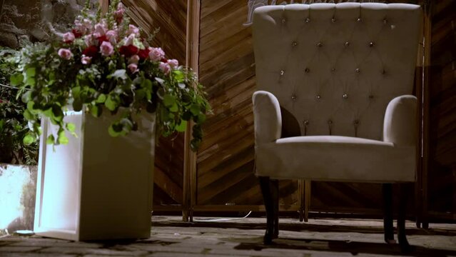 A chair and a beautiful bouquet of flowers 
