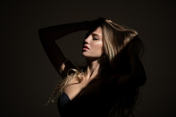 Sensual woman with shadows on beautiful face. Sensual girl with art shadow light.