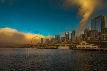 2022-01-29 THE SEATTTLE WATERFRONT WITH THE BIG WHEEL AND A CLOUD BANK MOVING IN AGAINST A BRIGHT...