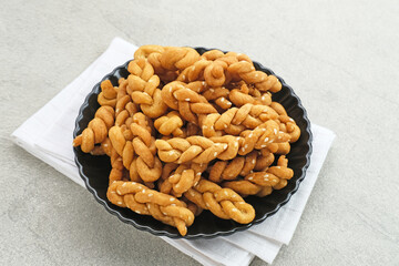 Kue Tambang or Untir untir is a traditional Indonesian cookies made from wheat flour, sugar, eggs and sesame seeds. Selected focus.
